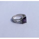 A 10 carat amethyst and diamond five stone ring. A