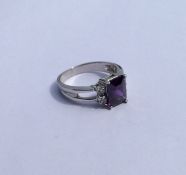 A 10 carat amethyst and diamond five stone ring. A