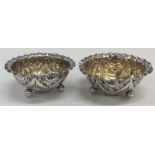 A pair of silver salts with crimped rims embossed
