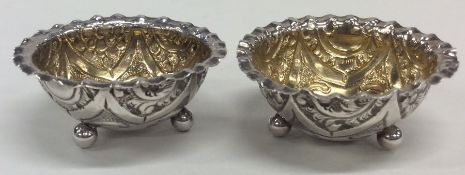 A pair of silver salts with crimped rims embossed