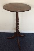 An early Victorian circular occasional table on sp