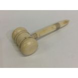 A small tapering ivory gavel with turned handle. E