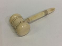 A small tapering ivory gavel with turned handle. E