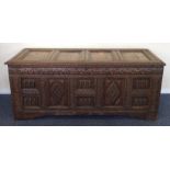 A massive Antique oak panelled coffer with carved
