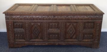 A massive Antique oak panelled coffer with carved