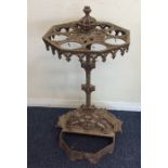 A cast iron umbrella stand decorated with scrolls.