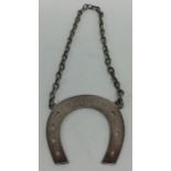 An unusual wine label in the form of a horseshoe o