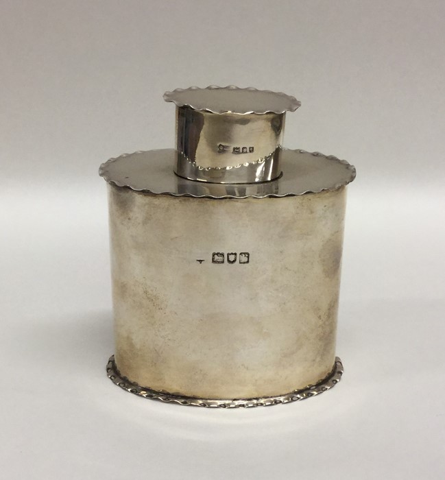 A good silver plain oval tea caddy with crimped ri