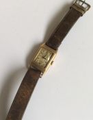 A gent's 9 carat wristwatch on leather strap. Appr