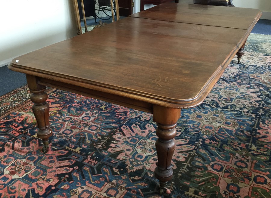A large Victorian mahogany extending table with th