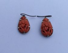 A pair of good quality Chinese carved coral earrin