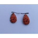 A pair of good quality Chinese carved coral earrin