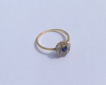 A sapphire and diamond daisy head cluster ring in