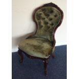 A Victorian button back nursing chair on cabriole