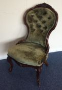 A Victorian button back nursing chair on cabriole