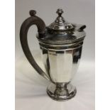 A heavy silver water jug with panelled sides. Shef