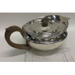A rare silver Georgian teapot with gadroon rim and