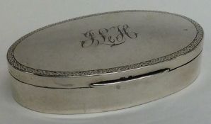 An oval silver ring box with engraved decoration.