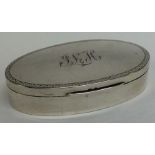An oval silver ring box with engraved decoration.