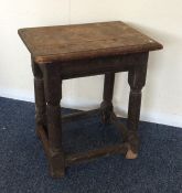 A Georgian oak joint stool with stretcher base. Es