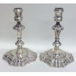 A pair of heavy cast George II silver candlesticks