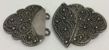 A Russian silver buckle with filigree decoration.