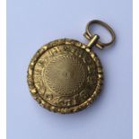 An Antique gilt locket with loop top and fitted in