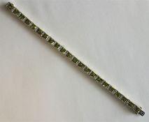 A good quality peridot and diamond line bracelet w