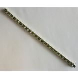 A good quality peridot and diamond line bracelet w