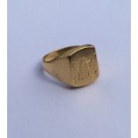 An 18 carat gent's signet ring of textured form. A
