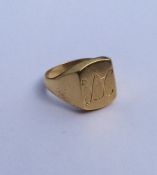 An 18 carat gent's signet ring of textured form. A