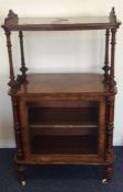 A Victorian walnut music cabinet with pierced deco