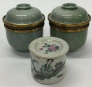 A pair of celadon pots and covers together with a