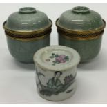 A pair of celadon pots and covers together with a