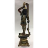 A large gilt figure in the form of a Blackamoor on