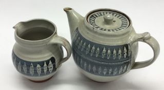 MARIANNE DE TREY: A pottery teapot and matching cr