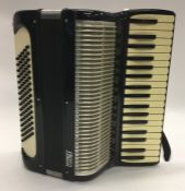 A cased accordion by Frisco. Est. £30 - £50.