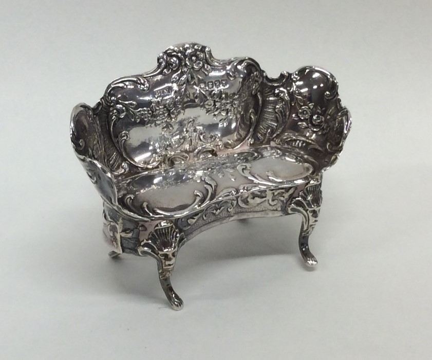 An Edwardian silver miniature sofa attractively de