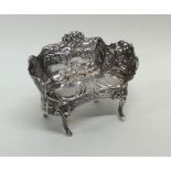 An Edwardian silver miniature sofa attractively de