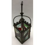 A brass mounted and stained glass hanging lampshad