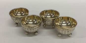 An unusual set of four silver gilt salts in the fo