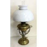 A stylish brass mounted oil lamp. Est. £40 - £60.