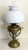 A stylish brass mounted oil lamp. Est. £40 - £60.