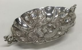 An oval silver bon bon dish decorated with flowers,