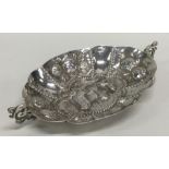 An oval silver bon bon dish decorated with flowers,