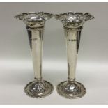 An attractive pair of Edwardian silver spill vases