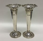 An attractive pair of Edwardian silver spill vases