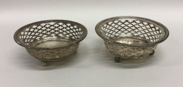 A pair of small Edwardian bonbon dishes on ball fe