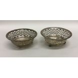 A pair of small Edwardian bonbon dishes on ball fe