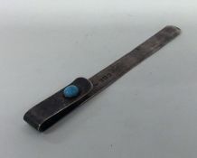 A novelty silver paperclip inset with turquoise. L